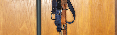 Set of Floris van Bommel belts displayed on a wooden surface
