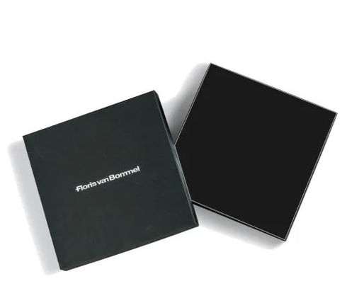Two black square product boxes on a white background, with one box lid showing the white printed brand name 'florivanBommel'.