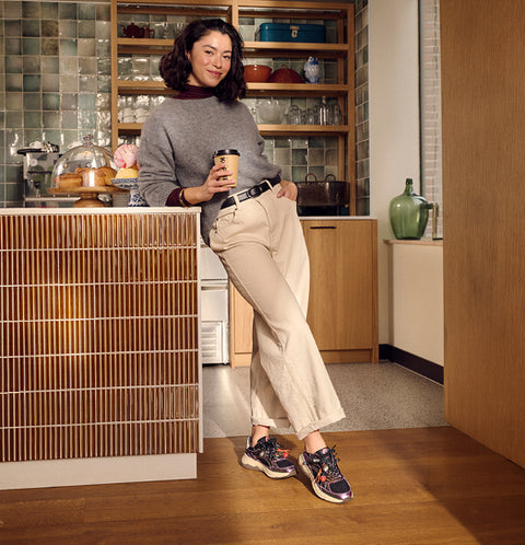 Woman wearing colorful Floris van Bommel sneakers at home