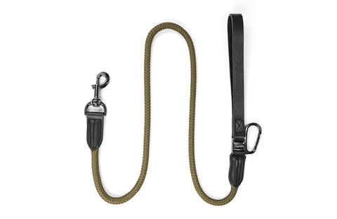 A dog leash Floris van Bommel with a braided olive green rope section, black leather handle and trim, and black metal hardware, shown on a plain white background.