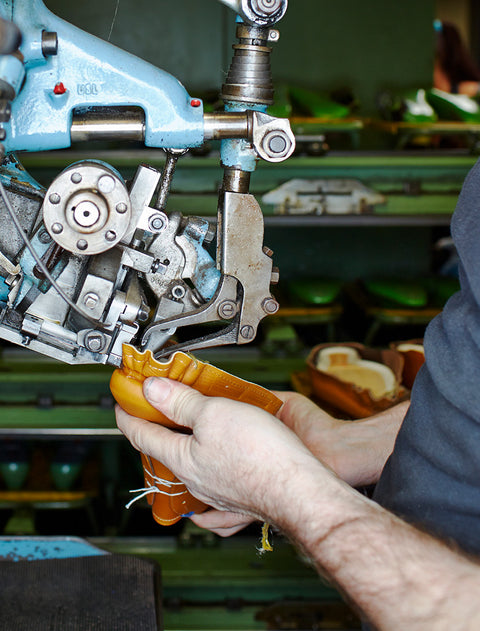 Person using a machine tool with a blurred workshop background. Floris van  Bommel