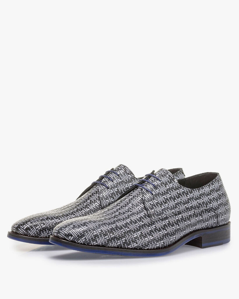 Grey lace shoe with a black graphic print