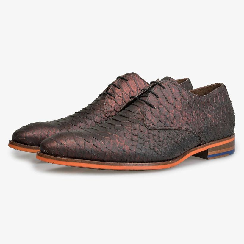 Leather lace shoe with snake print and orange outsole